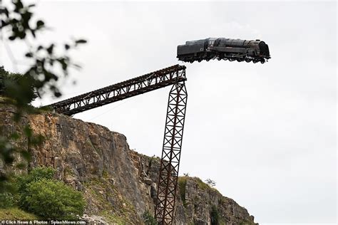 images train going off cliff